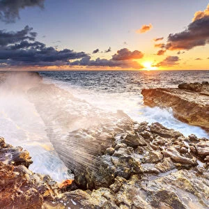 Waves crashing on cliffs at sunrise, Devils Bridge, Antigua, Antigua and Barbuda