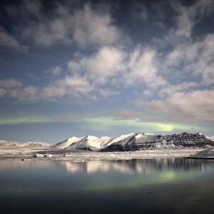 Weak winter Aurora Borealis (Northern Lights) over Jokulsarlon Glacial Lagoon, South Iceland