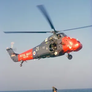 Wessex helicopter winching up survivior in rescue from sea