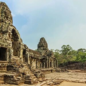West inner gallery towers and four of the 216 carved faces at Bayon temple in Angkor