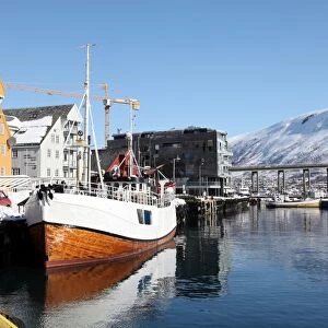 The whaler that used to go to Svalbard, with warehouses behind that have been converted into offices, Tromso, Troms, Norway, Scandinavia, Europe