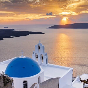 A white church with blue dome overlooking the Aegean Sea at sunset, Santorini, Cyclades, Greek Islands, Greece, Europe