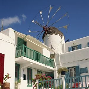 White house with windmill in the background on Mykonos