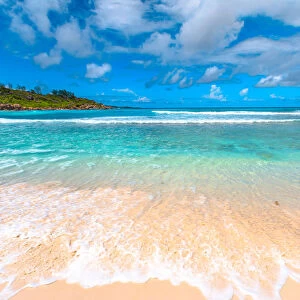 White sandy beach and turquoise clear sea of Anse Cocos, La Digue, Seychelles, Indian