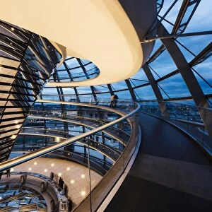 Wide angle interior view of The Dome of the Reichstag building at night, designed