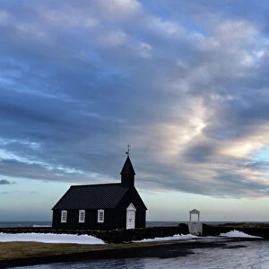Winter view at dusk of black wooden church at Budir, Snaefellsnes Peninsula, Iceland