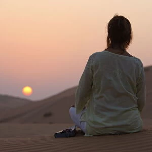 Woman with Bible in the desert, Abu Dhabi, United Arab Emirates, Middle East