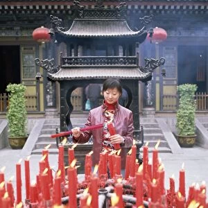 Woman with candle and incense offerings, Big Goose Pagoda temple, Xian