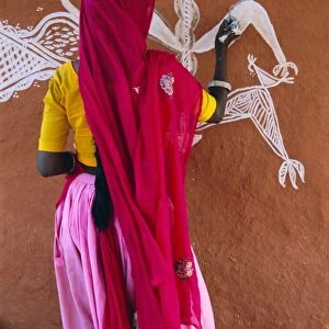 Woman decorating her house with traditional local designs