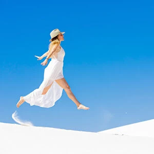 Woman jumping on the Gypsum Sand Dune, White Sands, New Mexico, United States of America