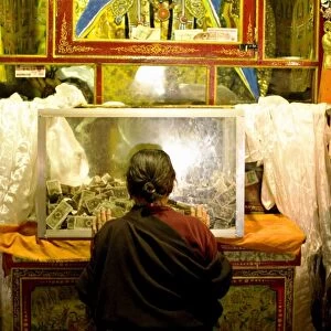 Woman pays respect at Meru Nyingba Buddhist monastery, Bharkor, Lhasa, Tibet, China, Asia