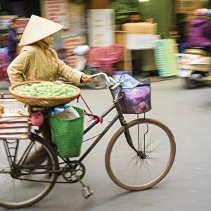 Woman pushing a bicycle in Old Quarter, Hoan Kiem District, Hanoi, Vietnam, Indochina