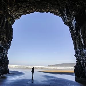 Woman standing in the giant Cathedral caves, The Catlins, South Island, New Zealand, Pacific