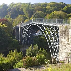 Worlds first iron bridge spans the banks of the River Severn in autumn sunshine, Ironbridge