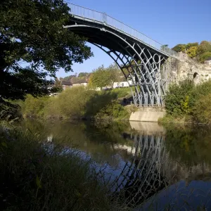 Worlds first iron bridge spans the banks of the River Severn in autumn sunshine, Ironbridge