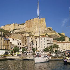 Yacht moored in harbour, with the citadel behind, Bonifacio, Corsica, France