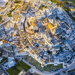 Zenithal aerial view of the old town of Ostuni at sunset, Apulia, Italy, Europe