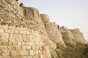 The 15 metre high curtain walls of the fourteenth century Tughluqabad Fortress in Delhi