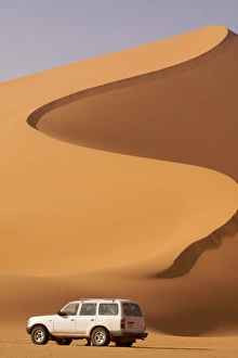 Fezzan Desert Prints: A 4X4 on the dunes of the erg of Murzuk in the Fezzan Desert, Libya, North Africa, Africa