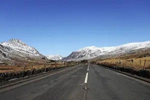 Main Road Prints: The A5 road runs through past snow-capped mountains in Snowdonia National Park