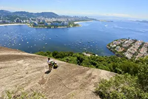 Typically Brazilian Prints: Abseilers in Morro da Urca in Rio de Janeiro with panoramic view in the background