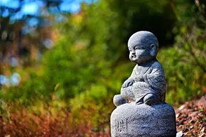 Meditation Prints: Adorable stone sculpture of a child monk in Nuona Pagoda Temple