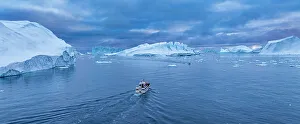 Ice Formations Prints: Aerial of a boat between the icebergs of the Ilulissat Icefjord