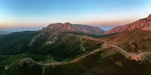 Open Space Prints: Aerial drone panoramic view of a camper van on a mountain road at sunset