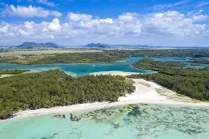 Drone Shot Prints: Aerial by drone of white sand beach with turquoise sea surrounded by tropical trees