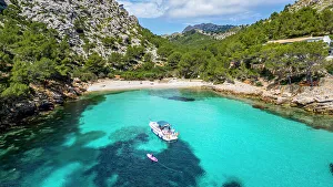 Cove Prints: Aerial of a little motorboat in a bay on the Formentor Peninsula