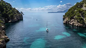 Passage Prints: Aerial of a little sailingboat in a bay on the Formentor Peninsula