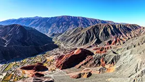 Tones Prints: Aerial panoramic of the colorful striated mountains surrounding the old town of Purmamarca