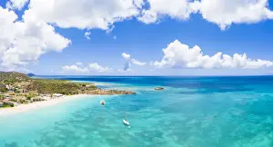 Aerial panoramic by drone of boats in the blue Caribbean Sea approaching to Turners Beach