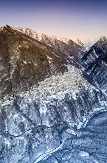 Lombardy Prints: Aerial panoramic by drone of Premana village during winter dusk, Valsassina