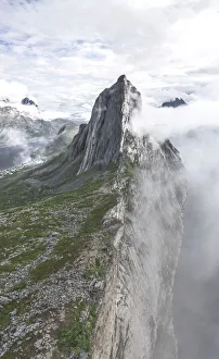 Aerial panoramic view of Mount Segla emerging from fog, Senja island, Troms county