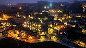 Night Sky Prints: Aerial of Sassi di Matera at night, UNESCO World Heritage Site, Basilicata, Italy, Europe