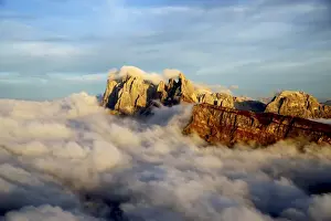 Aerial shot from Seceda of Odle surrounded by clouds at sunset in the Dolomites, Val Funes