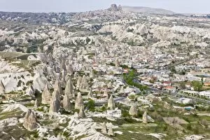 Aerial of the town of Goreme with the Rock Castle of Uchisar on the horizon