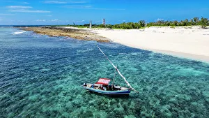 Crystal Clear Prints: Aerial of a traditional Dhow on a white sand beach