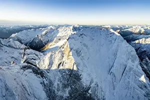 Graubunden Prints: Aerial vew of majestic rocks of the snowcapped Pizzo Badile in winter, Val Bregaglia