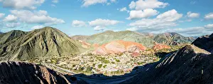 Aerial view of the ancient village of Purmamarca perched in a valley surrounded by mountains, Argentina