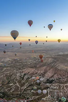Outdoor Activity Prints: Aerial view of Cavusin and hot air balloons at dawn