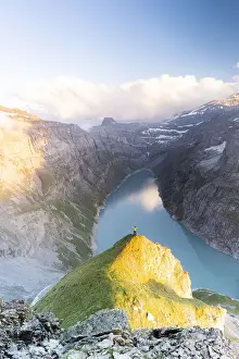 Arms Outstretched Prints: Aerial view of cheerful man with outstretched arms admiring lake Limmernsee at sunset