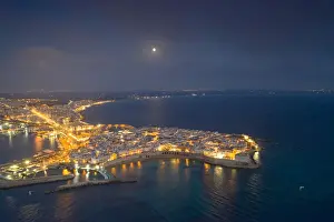 Gallipoli Prints: Aerial view of the coastal town of Gallipoli illuminated at night, Lecce province