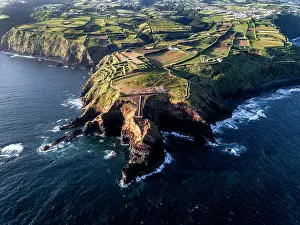 Lighthouses Prints: Aerial view of the coasts and cliffs of the island of Sao Miguel over the lighthouse of Farolim dos Fenais da Ajuda