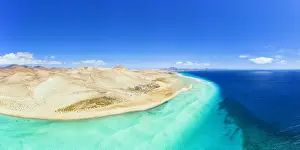 Aerial view of desert landscape of Jandia Nature Park washed by crystal sea, Costa Calma