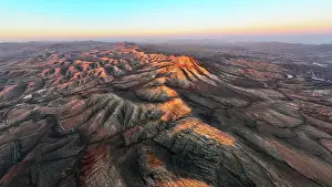 Canary Prints: Aerial view of desert mountains and volcanic landscape at sunset from Sicasumbre viewpoint