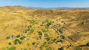Settlement Prints: Aerial view of a destroyed village in Qarabaqh with remnants of buildings and nature recovery in Azerbaijan