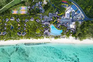 Directly Above Prints: Aerial view by drone of luxury tourist resort on palm-fringed beach facing the tropical