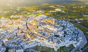 Drone Shot Prints: Aerial view by drone of the old town of Ostuni at sunset, Apulia, Italy, Europe